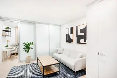 a living room with a white couch and a table at 75-1A NEW Prime UES W D in unit Elevator in New York