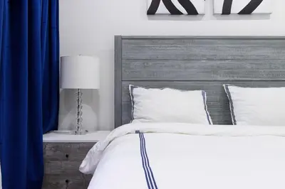 a bedroom with a bed with a wooden headboard at 75-1B NEW Prime Upper East W D Elevator in New York