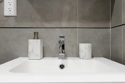 a bathroom sink with two candles on top of it at 75-1B NEW Prime Upper East W D Elevator in New York