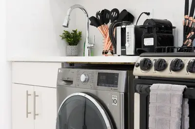 a kitchen with a washing machine and a counter at 62-3A NEW Prime UES W D in unit Walk 2 C park in New York