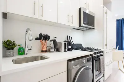 a white kitchen with a sink and a dishwasher at 62-3A NEW Prime UES W D in unit Walk 2 C park in New York