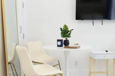 a white table with white chairs and a plant on it at 62-3A NEW Prime UES W D in unit Walk 2 C park in New York