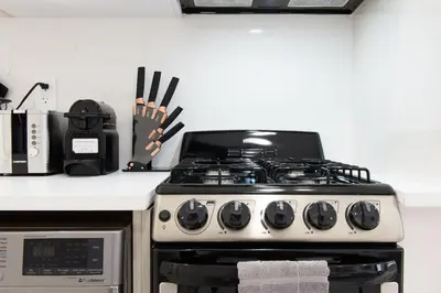 a stove top oven in a kitchen next to a counter at 62-3A NEW Prime UES W D in unit Walk 2 C park in New York