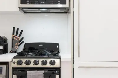 a kitchen with a stove and a microwave at 62-3A NEW Prime UES W D in unit Walk 2 C park in New York