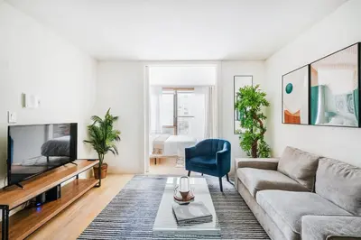 a living room with a couch and a tv at 75-3C Brand New Duplex 3BR W D in the unit in New York