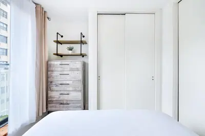 a bedroom with a bed and a dresser at 75-3C Brand New Duplex 3BR W D in the unit in New York