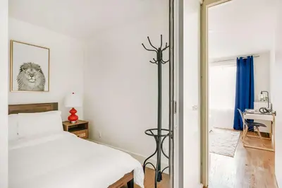 a bedroom with a bed and a desk and a mirror at 75-3C Brand New Duplex 3BR W D in the unit in New York