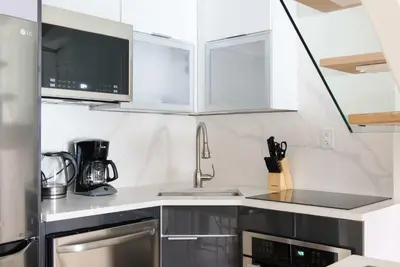 a kitchen with white cabinets and a sink at 75-3C Brand New Duplex 3BR W D in the unit in New York