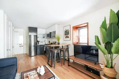 a kitchen and living room with a table and chairs at 75-2A furnished 1BR W D Elev central park in New York
