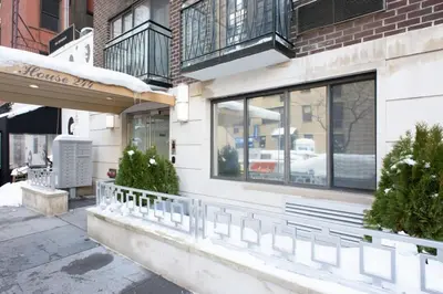 a store front with windows and plants on a sidewalk at 75-2A furnished 1BR W D Elev central park in New York