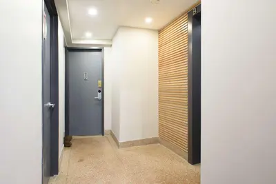 a hallway with a blue door and a wooden wall at 75-2A furnished 1BR W D Elev central park in New York