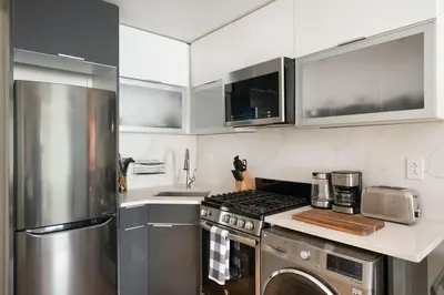 a kitchen with a stainless steel stove and refrigerator at 75-2A furnished 1BR W D Elev central park in New York