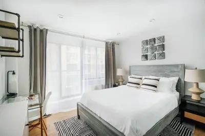 a bedroom with a large white bed and a window at 75-2D NEW Prime UES W&D Balcony Elevator in New York