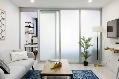 a living room with a couch and a table at 75-2C Furnished 1BR W D Elev WD Central park in New York