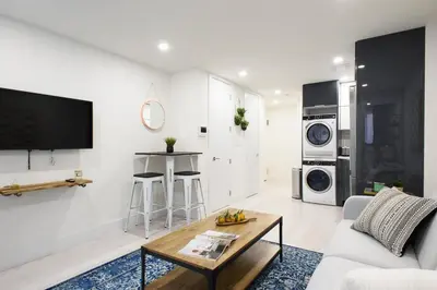 a living room with a couch and a coffee table at 75-2C Furnished 1BR W D Elev WD Central park in New York