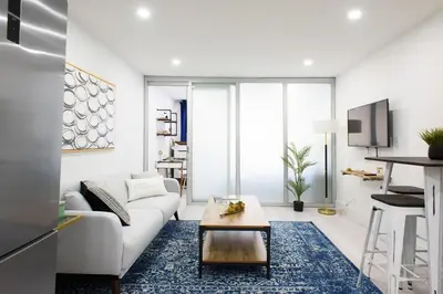 a living room with a white couch and a coffee table at 75-2C Furnished 1BR W D Elev WD Central park in New York