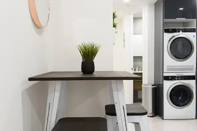 a table with a plant on it in a kitchen at 75-2C Furnished 1BR W D Elev WD Central park in New York