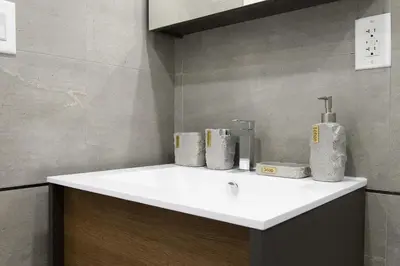 a bathroom with a sink with toiletries on it at 75-2C Furnished 1BR W D Elev WD Central park in New York