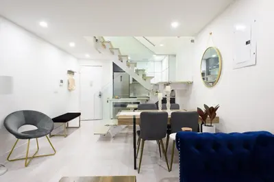 a living room with a dining room table and chairs at 75-3A 3Br Duplex Prime UES WD in unit Sleeps 6 in New York