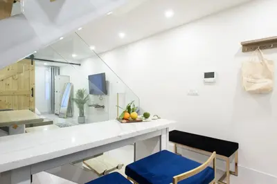 a kitchen with a white counter and blue chairs at 75-3A 3Br Duplex Prime UES WD in unit Sleeps 6 in New York