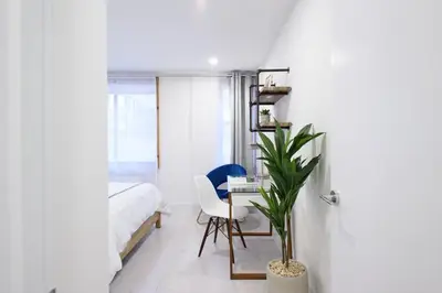 a bedroom with a bed and a desk and a chair at 75-3A 3Br Duplex Prime UES WD in unit Sleeps 6 in New York