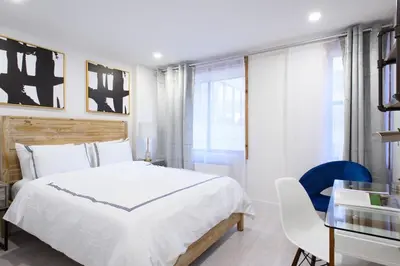 a bedroom with a large white bed and a desk at 75-3A 3Br Duplex Prime UES WD in unit Sleeps 6 in New York