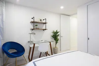 a bedroom with a bed and a desk and a blue chair at 75-3A 3Br Duplex Prime UES WD in unit Sleeps 6 in New York