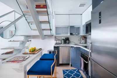 a kitchen with blue chairs and stainless steel appliances at 75-3B 3BR Luxury duplex BRAND NEW &D Elevator in New York
