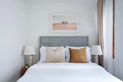 a bedroom with a large white bed with two lamps at 75-3B 3BR Luxury duplex BRAND NEW &D Elevator in New York