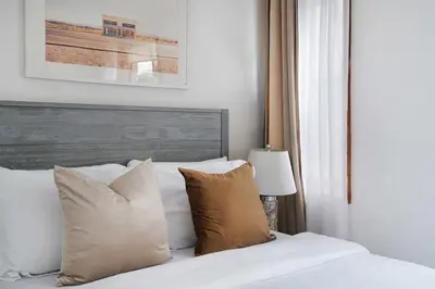 a bedroom with a bed with white sheets and pillows at 75-3B 3BR Luxury duplex BRAND NEW &D Elevator in New York