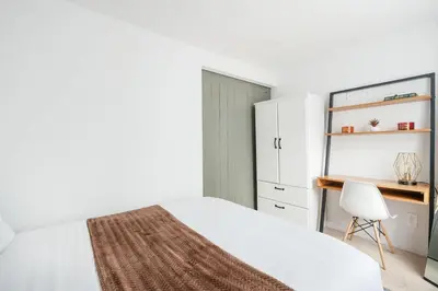 a bedroom with a bed and a desk and a chair at 75-4A Brand new 3BR Prime UES W D in unit in New York