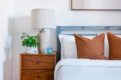 a bedroom with a bed with a nightstand with a lamp at 75-4B Duplex 3BR Brand new W D Prime UES in New York
