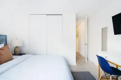 a bedroom with a bed and a desk and a chair at 75-4B Duplex 3BR Brand new W D Prime UES in New York