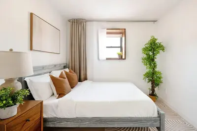 a bedroom with a white bed and a window at 75-4B Duplex 3BR Brand new W D Prime UES in New York