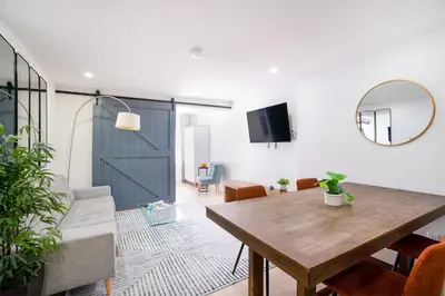 a living room with a wooden table and a mirror at 75-4B Duplex 3BR Brand new W D Prime UES in New York