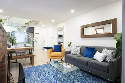a living room with a couch and a mirror at 75-5 Luxury 3BR Duplex W d Elevator bldg in New York