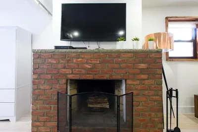 a fireplace with a flat screen tv on top of it at 75-5 Luxury 3BR Duplex W d Elevator bldg in New York