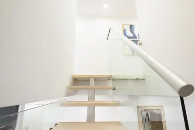 a stairwell with a table and a light pole at 75-5 Luxury 3BR Duplex W d Elevator bldg in New York