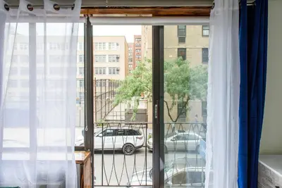 a window with a view of a car on a street at 75-5C 3BR LUXURY Duplex BRAND NEW W&D Elevator in New York