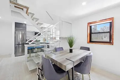 a kitchen and dining room with a table and chairs at 75-5C 3BR LUXURY Duplex BRAND NEW W&D Elevator in New York