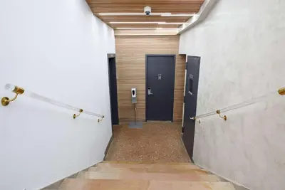 a hallway with a black door in a building at 75-5C 3BR LUXURY Duplex BRAND NEW W&D Elevator in New York