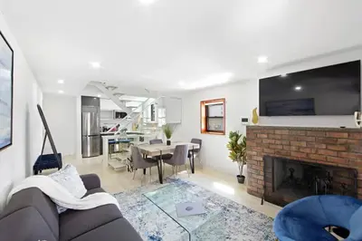 a living room with a couch and a fireplace at 75-5C 3BR LUXURY Duplex BRAND NEW W&D Elevator in New York