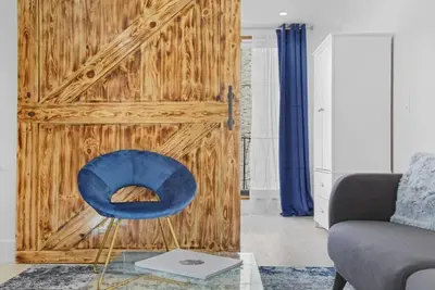 a blue chair sitting in a living room at 75-5C 3BR LUXURY Duplex BRAND NEW W&D Elevator in New York