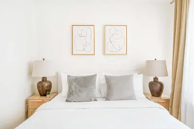 a bedroom with a white bed with two lamps at 75-4C New Duplex 3BR W D Elevator Walk to C park in New York