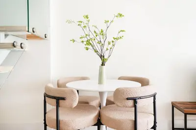 a white table with chairs and a vase with flowers at 75-4C New Duplex 3BR W D Elevator Walk to C park in New York