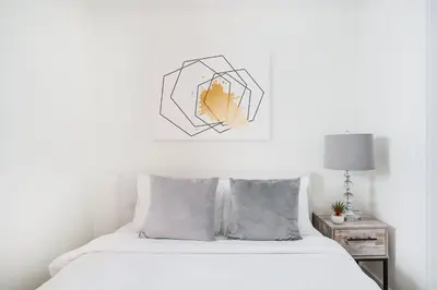 a bedroom with a bed and a picture on the wall at 75-4C New Duplex 3BR W D Elevator Walk to C park in New York