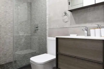 a bathroom with a shower and a toilet and a sink at 75-1D New 1BR prime UES W D the unit Best Value in New York
