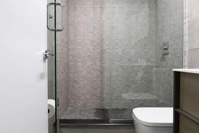 a bathroom with a glass shower with a toilet at 75-1D New 1BR prime UES W D the unit Best Value in New York