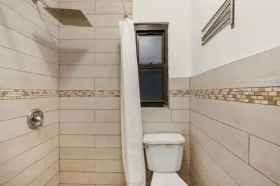 a bathroom with a toilet and a shower at 428-2W Newly Furnished Prime Location 2BR Sleeps 5 in New York