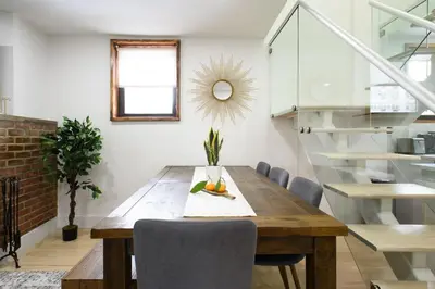 a dining room with a wooden table and chairs at 75-5D NEW Quality 3BR Duplex W&D Elevator in New York